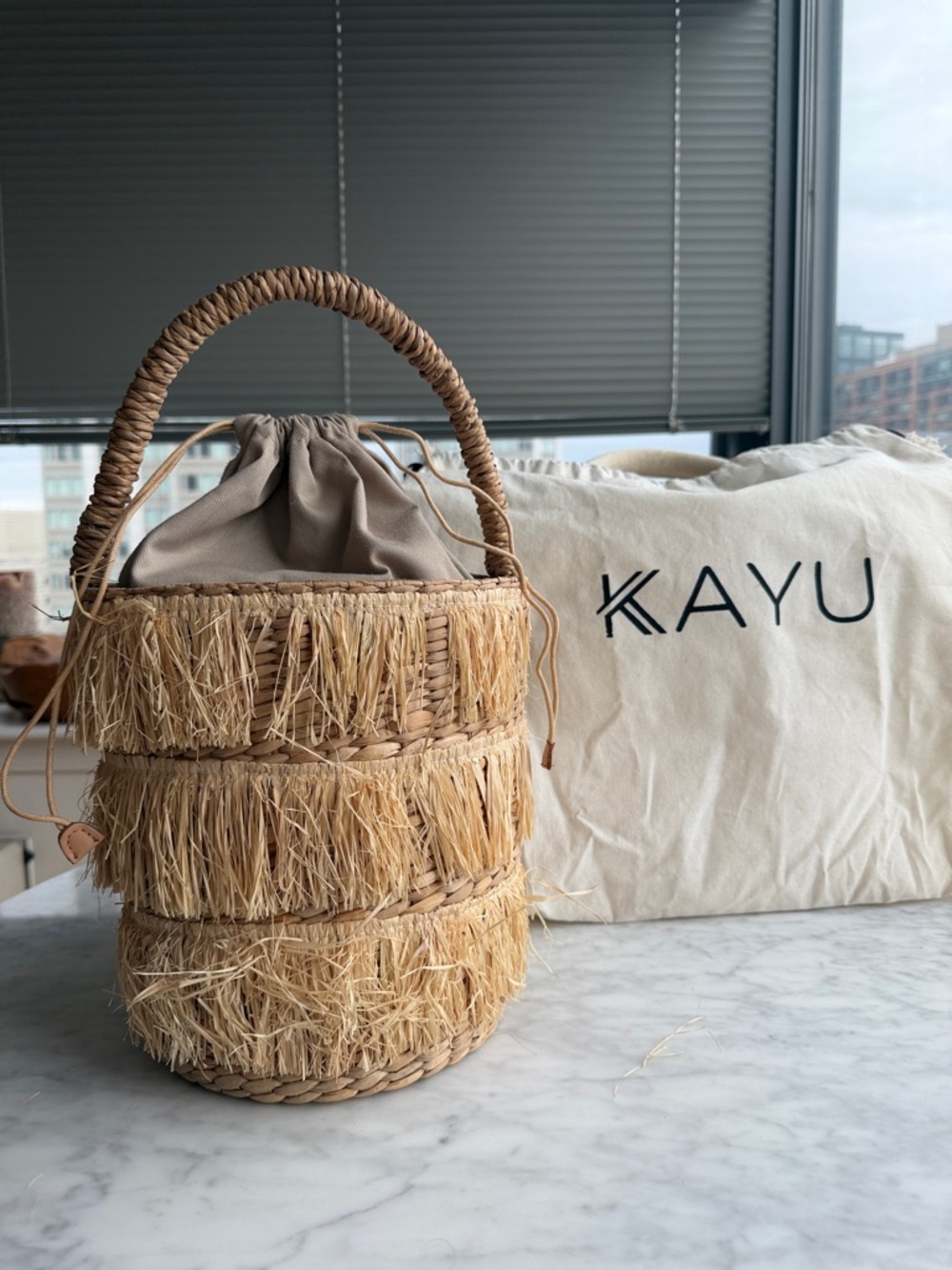 Kayu Natural Raffia Fringe Bucket Bag in Beige